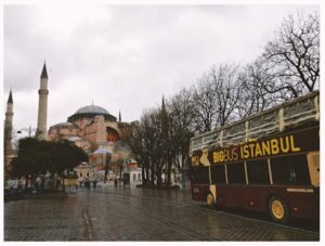 Brown Bigbus Istanbul Traveling on Road Near Brown Dome Building